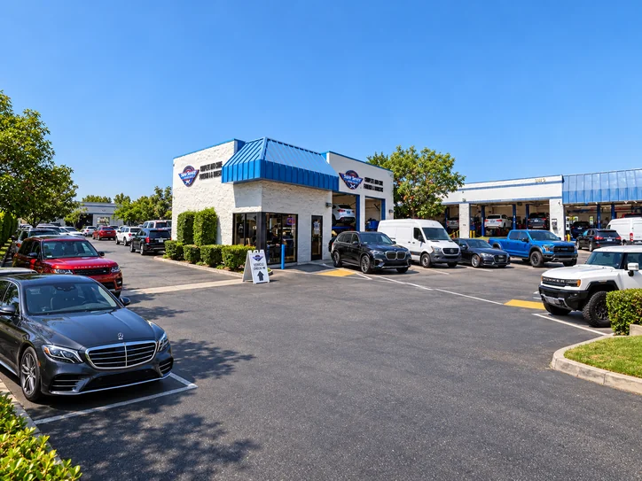 Wide view of Super Service of Pomona Valley facility and customer vehicles